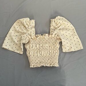 small cream and black polka dot crop top with scrunched torso and puffed sleeves